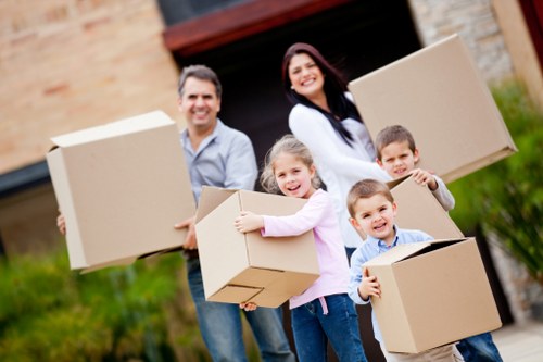 Packed moving boxes and furniture prepared for collection in Hounslow