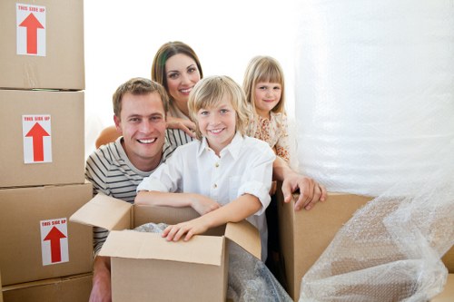 Moving team loading boxes and household items on a residential street